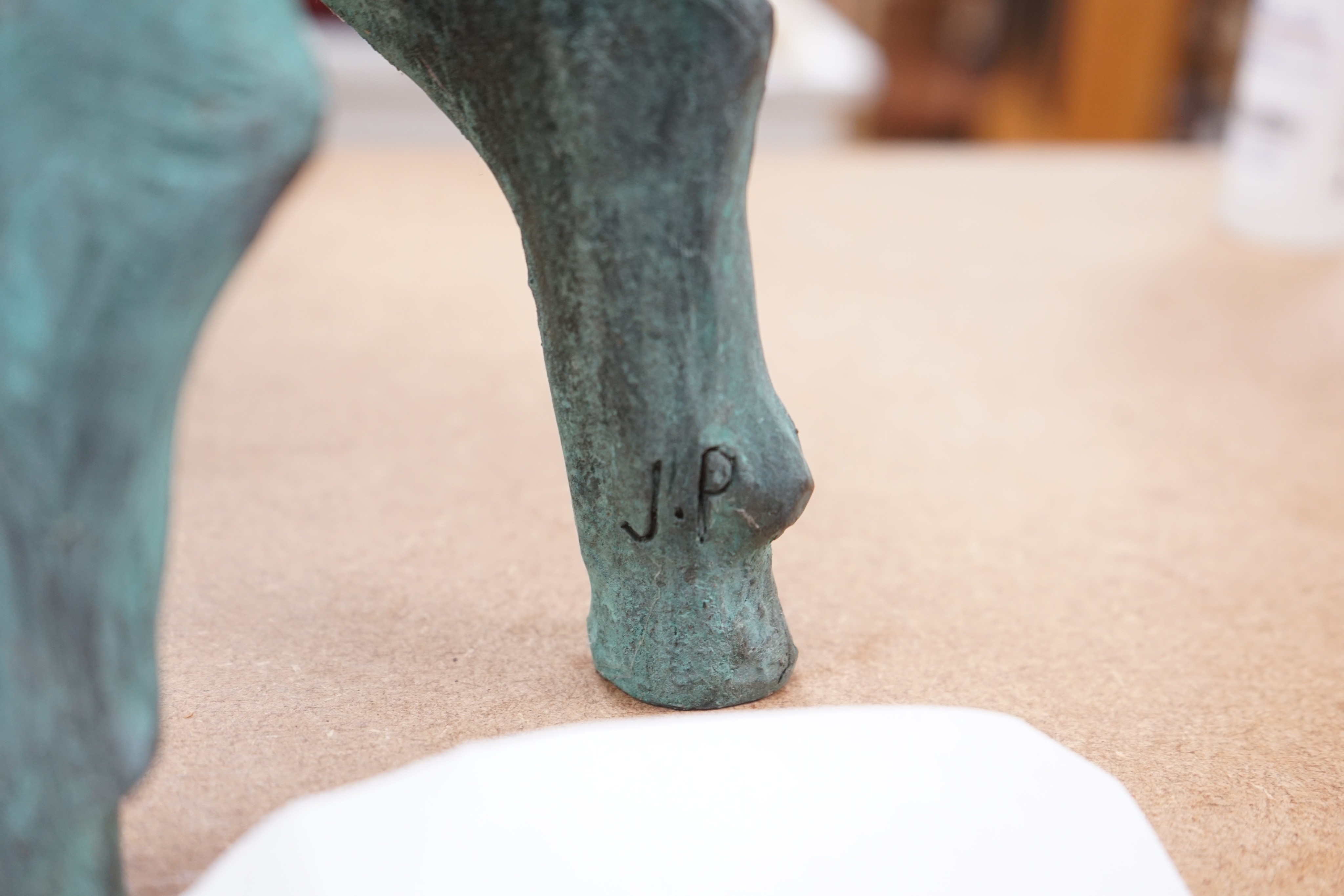 A cold cast resin bronze pig initialled 'JP', 40cm wide